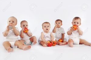 6309816-Group-of-babies-with-apples-sitting-on-white-studio-background-Stock-Photo